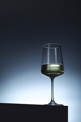 White wine in a transparent glass in low key