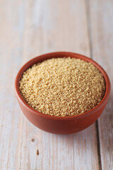 Dry couscous in a small ceramic bowl