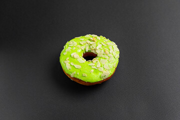 Close-up of Green doughnut or donut isolated on a black background. Food background.
