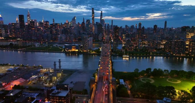 Stunning cityscape of New York in the lights. Spectacular Queensboro Bridge over East River at the backdrop of skyscrapers at night.