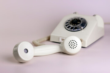 Retro, old, telephone on light pastels background. Close up minimal concept.