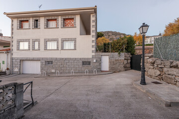 Exterior area of a single-family home with cement streets and iron streetlights