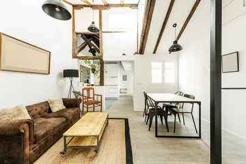 loft with high ceilings, updated vintage wood beams, industrial wood serving hatch and tables,...