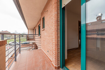 terrace of a house with green aluminum and glass sliding windows in a single-family residential house