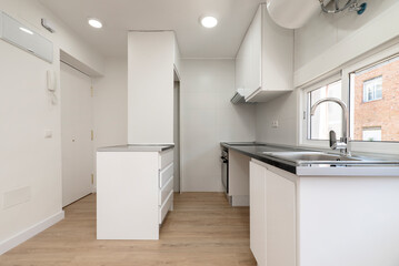 Kitchen with newly installed furniture in a simple and apartment with light wooden floors