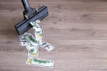 Robot vacuum cleaner sucks in dollars closeup