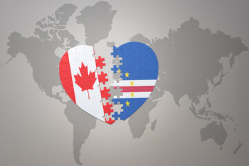 puzzle heart with the national flag of canada and cape verde on a world map background.Concept.