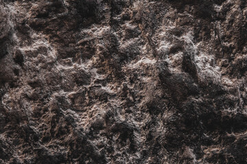 Brown wall texture. Stone background. Rock texture. Grunge Rough structure. Abstract texture. Rock surface with cracks. Rock pile. Paint spots.