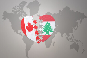 puzzle heart with the national flag of canada and lebanon on a world map background.Concept.