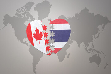 puzzle heart with the national flag of canada and thailand on a world map background.Concept.