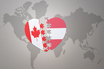 puzzle heart with the national flag of canada and austria on a world map background.Concept.
