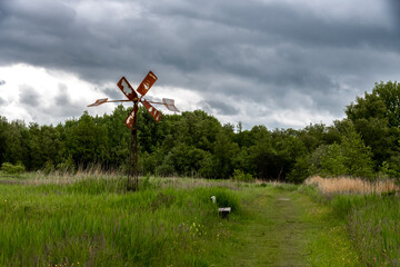 A rusty windmill pumping water into the fields © Joanna