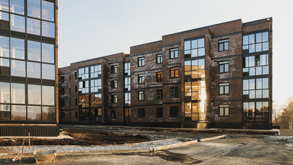 A new brick house stained with white efflorescence, a crystalline of salt, formed due to water being present in the bricks. Construction defects