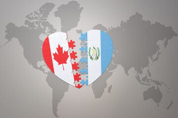 puzzle heart with the national flag of canada and guatemala on a world map background.Concept.