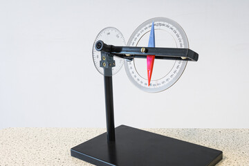 Special compass where not only the horizontal component, but also the vertical component of the direction of the earth's magnetic field can be measured. Used in physics class.