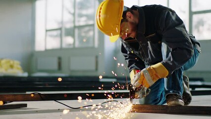 Good equipment constructor worker at construction site using the disc welding machine and cut the metals and creating big sparks - Powered by Adobe