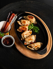 Fried gyoza dumplings with duck served with soy sauce