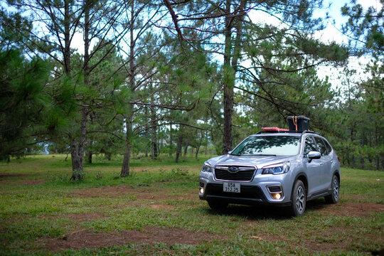 Da Lat, Vietnam - May 2022: Subaru Forester with camping luggage. Car to travel picnic camping in the forest. Stock image of camping summer activities. Adventure travel with car, tent
