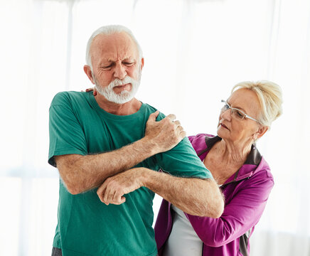 senior stretching exercise woman training sport fitness home gym exercising man couple pain shoulder injury back care health fit ache joint painful muscle backache problem medicine painful