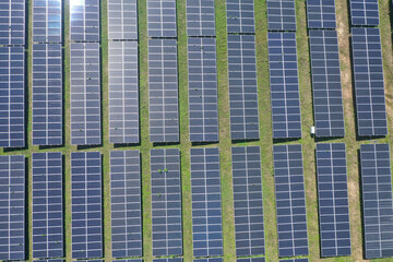 Aerial view of Ecology solar power station panels in the fields green energy. Landscape electrical...
