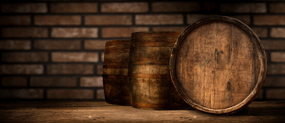 Beer. Still life with Vintage beer barrel and glass light beer. Fresh amber beer concept. Green hop...