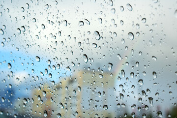 Drops of water on glass on background of rainbow