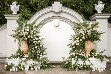 Arch for an outdoor wedding ceremony with candles