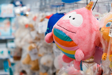 Shop toy store for babies. A soft toy close-up on a shopping trip with a blurry background.
