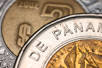 Close up shot of One Balboa bimetallic Republica de panama coin circa 2011. Mexican 2 peso coin is in the background.