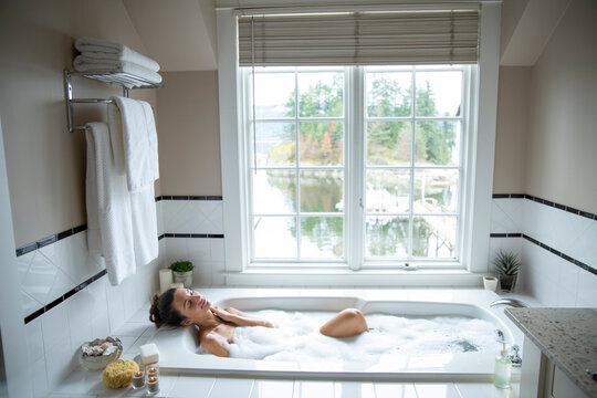 Young woman relaxing in bath