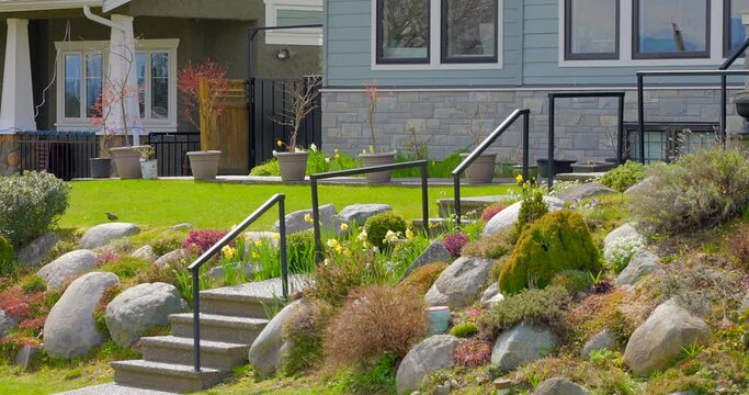 Establishing shot. Entrance of grey painted luxury house with stair steps, green trees and nice landscape in Vancouver, Canada, North America. Day time on June 2021. Still camera view. ProRes 422 HQ.