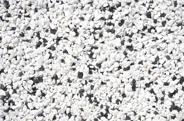 Top view of the surface with many small white and black stones