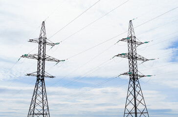 Towers and high-voltage power lines against the sky.