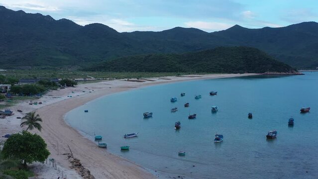 Top view, aerial view fishing harbor market from a drone. Royalty high-quality free stock video footage of Mui Ne fishing harbour or fishing village. Fishing harbor is a popular tourist destination