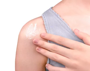  A girl applying sunscreen isolated on white background.Skincare concept. © Albert Ziganshin