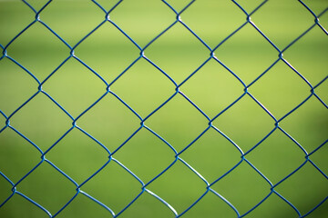 Fototapeta premium Mesh fence on vernacular background. Fence details.