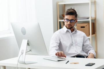 Obraz premium businessmen in a white shirt sits at a computer work documentation office