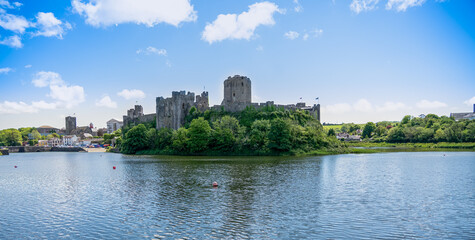 Fototapeta na wymiar view of the stunning Pembroke Castle over Pembroke river, blue sky background