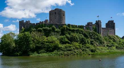 Fototapeta na wymiar view of the stunning Pembroke Castle over Pembroke river, blue sky background