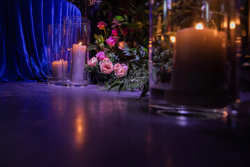 Bouquet of flowers and candles near the wedding table