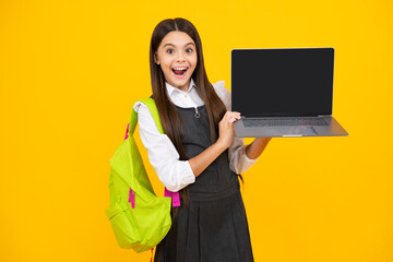 School girl hold laptop notebook on isolated studio background. Schooling and education concept....