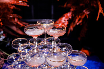 Fototapeta na wymiar Pyramid of martini glasses on the table