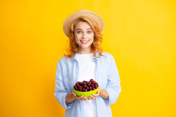 Young stylish woman isolated holding red colorful cherries. Berries harvest season. Summer diet with organic harvesting cherry.