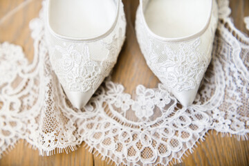 White wedding shoes on the lace veil
