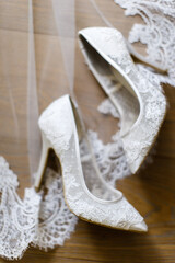 Wedding shoes and veil on the floor