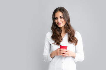Emotion of young beautiful woman drink hot coffee, beauty face natural makeup, isolated over gray background.