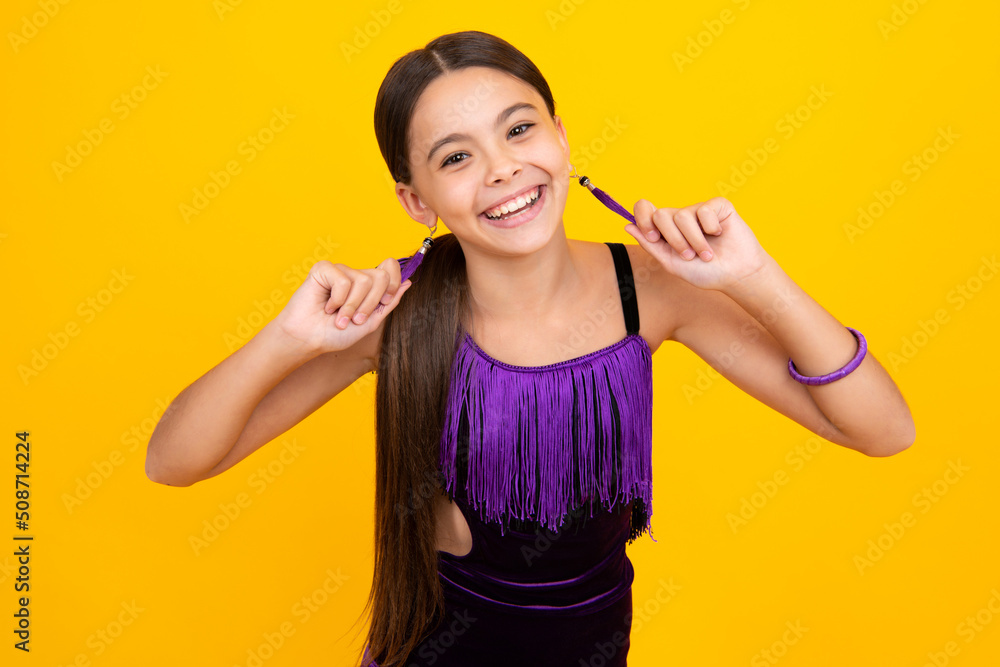 Wall mural cute young teenager girl against a isolated background. studio portrait of pretty beautiful child.