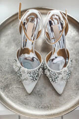 Wedding shoes with precious stones on the round tray