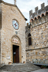Typical church in small village and colorful flowers in pots