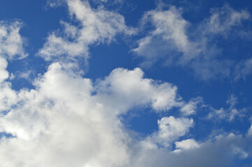 Naklejka na ściany i meble Beautiful white clouds in an azure sky